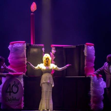 Dolly Parton appears onstage via a 40th birthday cake as she celebrates Dollywood's first opening day 40 seasons ago during an event at the Pigeon Forge park on May 2, 2025.