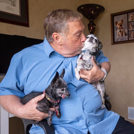 Dave Cook had little support while providing care for his wife, Pat, at home while she was dying. He retired to take care of her in 2018. When she developed lymphedema she became "virtually immobile." She had developed open sores and he had to administer pain medication despite having hospice care. Her pain was so great that she asked him to kill her, more than once. She died in December 2024. He is shown with his dogs Bucky, left, and Mickey on Tuesday, April 29, 2025 in   Racine, Wisconsin.