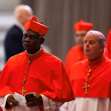 Cardinal Peter Turkson of Ghana arrives as Pope Francis' coffin is carried into St. Peter's Basilica at the Vatican on April 23, 2025.