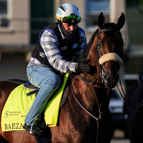 Rider Frankie Herrarte pats Kentucky Derby contender Baeza while waiting to go on the track for a workout Friday at Churchill Downs.