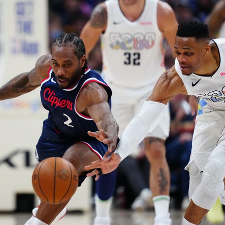 LA Clippers forward Kawhi Leonard (2) and Denver Nuggets guard Russell Westbrook (4) reach for a loose ball in the second half of Game 5