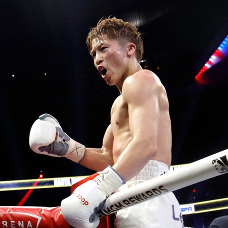 Undisputed junior featherweight champion Naoya Inoue celebrates after defeating Ramon Cardenas.