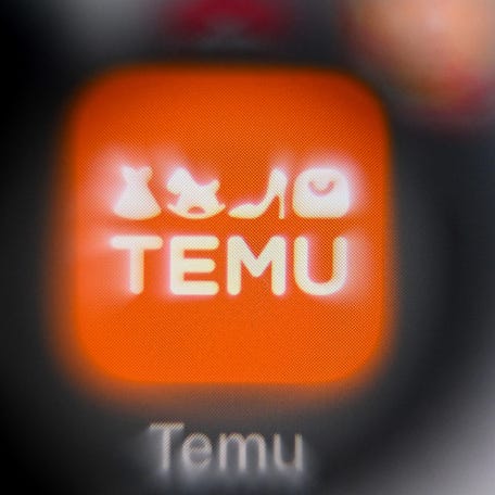 A photo illustration of the Temu app logo displayed on a mobile device.