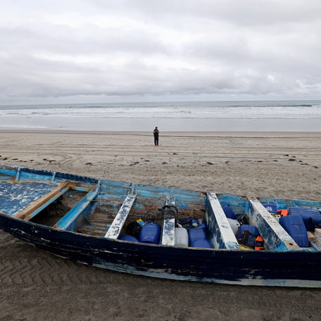 The vessel involved in a deadly panga boat capsizing off Torrey Pines State Beach sits on the beach after it was dragged from where it came ashore in Del Mar, California, on. May 5, 2025.