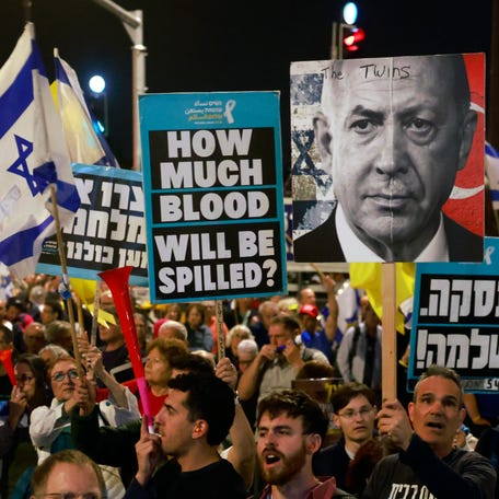 A protester holds a placard of Israeli Prime Minister Benjamin Netanyahu during a rally in Jerusalem on March 31, 2025, calling for an end to the war in Gaza and the return of all the hostages held by Hamas.