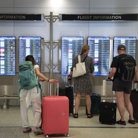 Travelers pass through the Miami International Airport on Dec. 20, 2024.