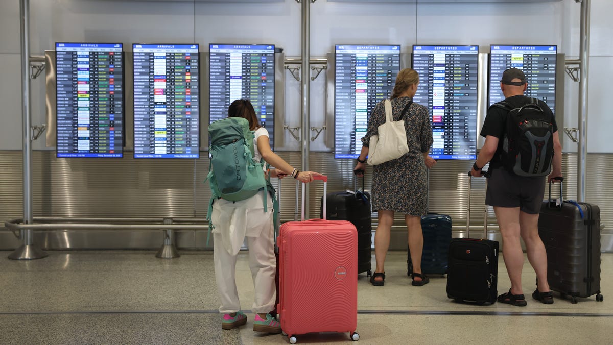 Travelers pass through the Miami International Airport on Dec. 20, 2024.