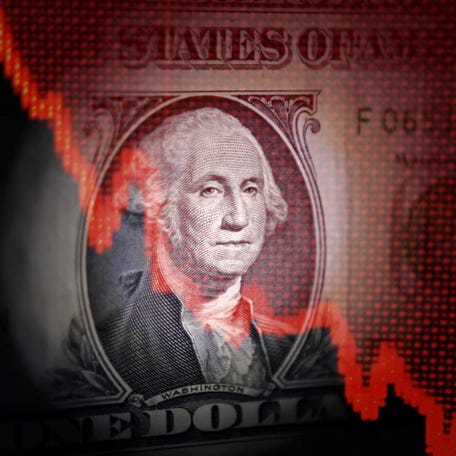 U.S. dollar banknote and decreasing stock graph are seen in this illustration taken April 25, 2025. REUTERS/Dado Ruvic/Illustration