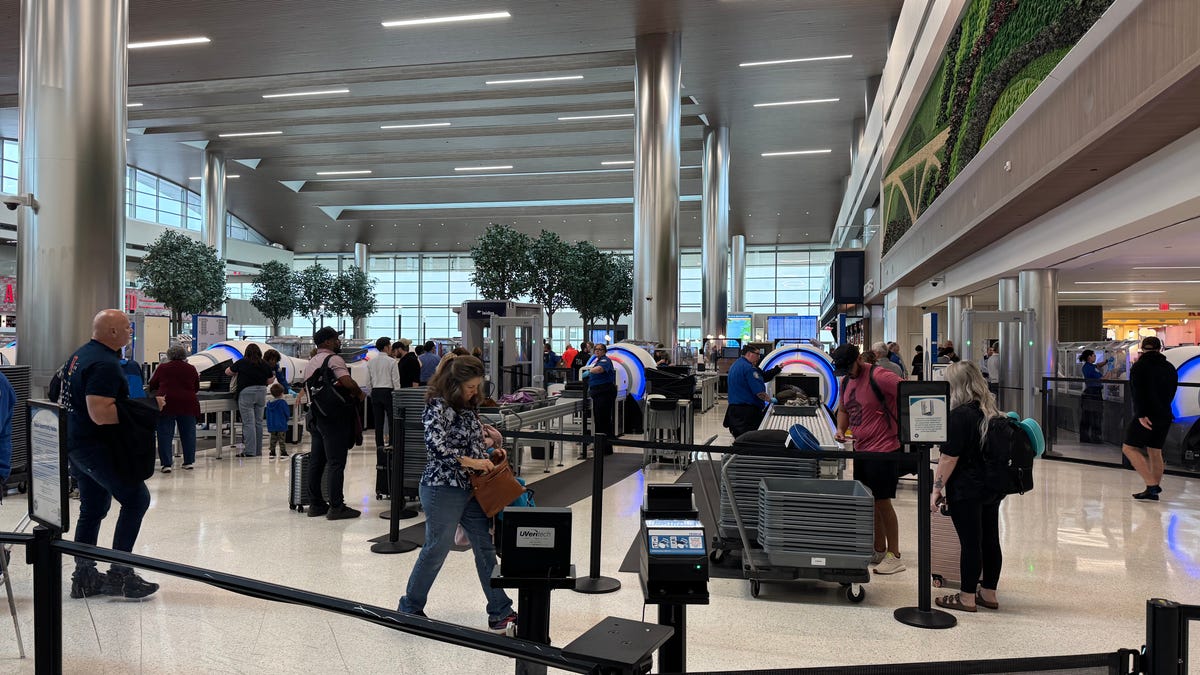 Travelers go through security at Nashville International Airport.