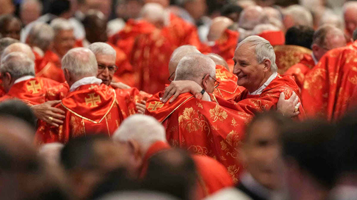 Italian cardinal Matteo Maria Zuppi (R) attends a mass for the Election of the Roman Pontiff, prior to the start of the conclave, at St Peter's Basilica in The Vatican, on May 7, 2025.