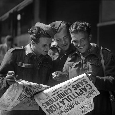 Smiling soldiers read, on May 8, 1945 in Paris, the special edition of the newspaper France Soir announcing the unconditional surrender of the German armed forces that ends World War II in Europe, during celebrations of the V-E Day (Victory in Europe Day). The act of capitulation of Germany was signed in Reims on May 7, 1945 then on May 8, 1945 in Berlin, at the headquarters of the Soviet forces, and ended the Second World War.