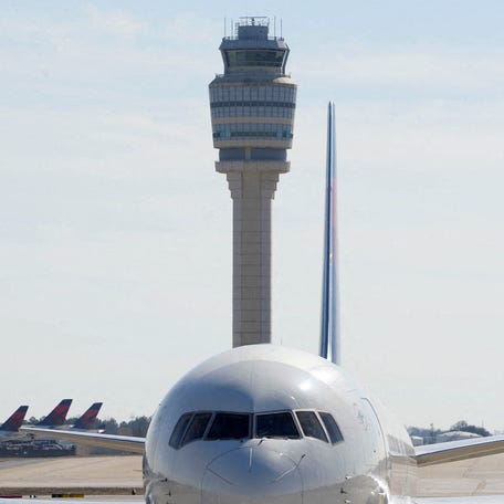 Atlanta's air traffic control tower is seen behind a plane at Hartsfield-Jackson Atlanta International Airport, in Georgia, U.S. February 1, 2025.
