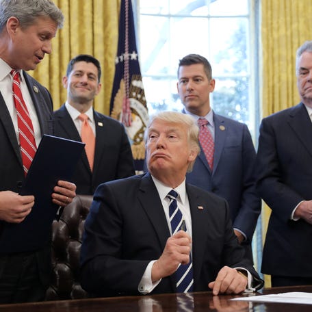 Representative Bill Huizenga (L) talks with U.S. President Donald Trump at the Oval Office of the White House in Washington, U.S., February 14, 2017.