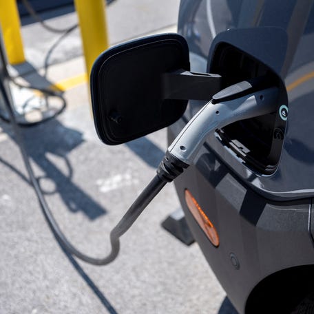 Amazon EV vans powered by Rivian are parked at charging stations at the Amazon Logistics Facility in Chicago, Illinois, U.S. July 21, 2022.