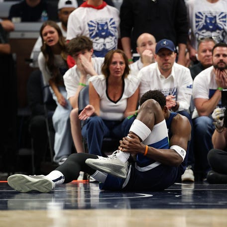 Anthony Edwards holds his ankle during the second quarter of Game 2 against the Warriors.