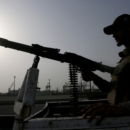 A paramilitary trooper mans a gun atop a vehicle as he keeps guard during a media tour of the Karachi Port, Pakistan, May 9, 2025. REUTERS/Shakil Adil