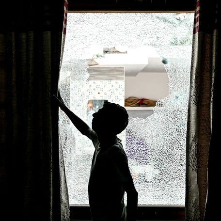 A man shows the shattered window of a house after cross-border shelling in Arnia town near the border area in India's Jammu region on May 10, 2025, amid a surge in border tensions between India and Pakistan. Pakistan launched counterattacks against India on May 10, after three of its air bases were struck overnight, and as the conflict between the nuclear-armed neighbours spiralled towards a full-blown war that sparked calls against "miscalculation". (Photo by Money SHARMA / AFP) (Photo   by MONEY SHARMA/AFP via Getty Images)