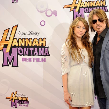 Miley Cyrus and Billy Ray Cyrus pose for photographers on the red carpet for the film "Hannah Montana: The Movie" in Munich on April 25, 2009.