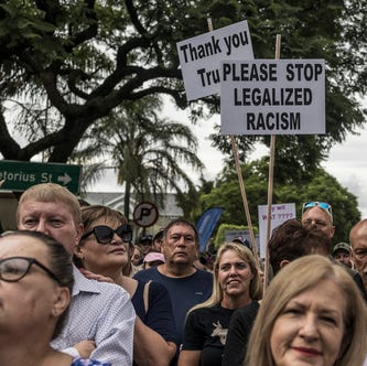 White South Africans supporting President Donald Trump and South African and US tech billionaire Elon Musk gather in front of the US Embassy in Pretoria, on February 15, 2025 for a demonstration.