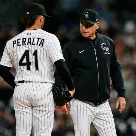 Colorado Rockies manager Bud Black talks to relief pitcher Luis Peralta during a game against the Milwaukee Brewers at Coors Field on April 9, 2025.