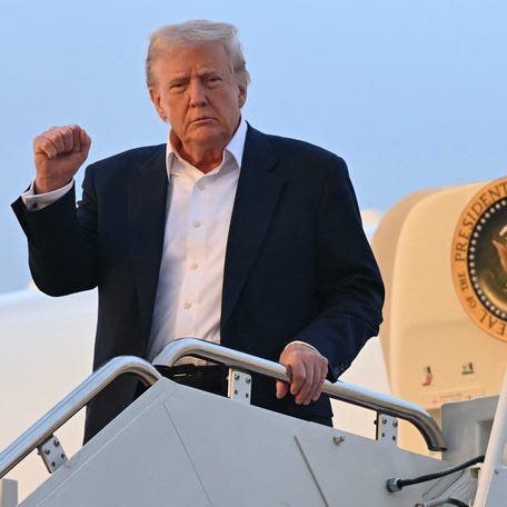 President Donald Trump is pictured disembarking from Air Force One upon arrival at Joint Base Andrews.