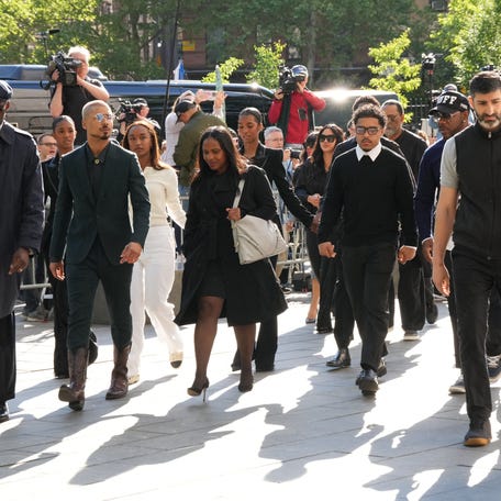 Quincy Brown and Justin Combs walk with other members of the Combs family as they arrive at federal court on May 12, 2025, in New York.