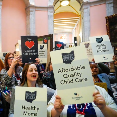 Demonstrators gather at the Ohio Statehouse on March 12, 2025, in Columbus to call for child care and health care for families.