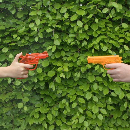 Water gun pistols pointed at each other