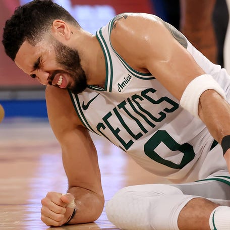 Jayson Tatum grimaces in pain after suffering a non-contact injury in the fourth quarter of Game 4.
