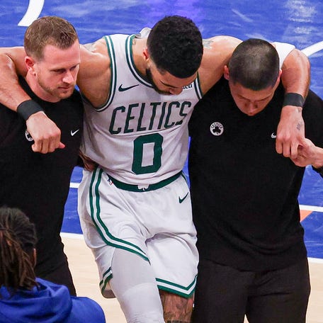 Jayson Tatum is helped off the court after an injury during Game 4.
