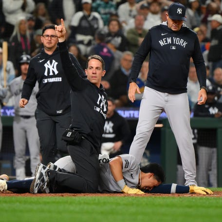 Trainers tend to Oswaldo Cabrera after being injured while scoring a run against the Seattle Mariners during the ninth inning at T-Mobile Park.