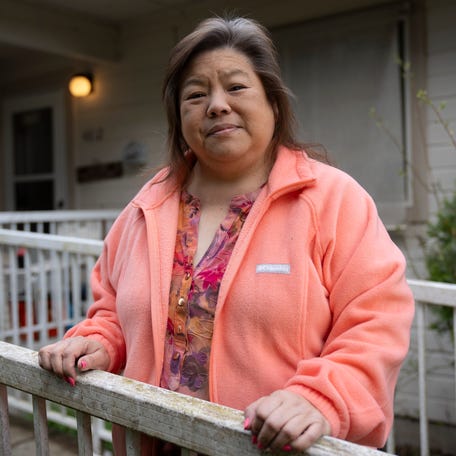 Elizabeth Oshiro stands for a portrait on the porch of the home she inherited from her mother on the day of her eviction after being disenrolled from the Nooksack Tribe in 2016 and fighting to keep her home for all these years.