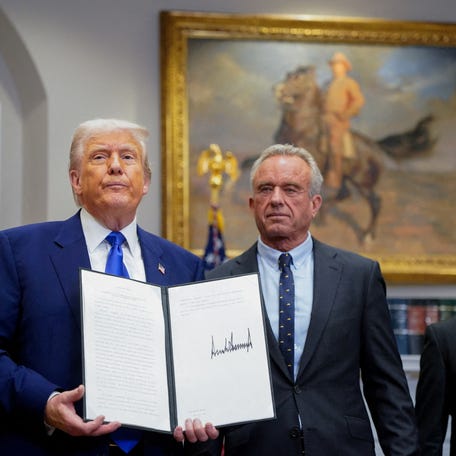 U.S. President Donald Trump holds an executive order on prescription drug pricing next to U.S. Health and Human Services (HHS) Secretary Robert F. Kennedy, Jr., during a press conference in the Roosevelt Room at the White House in Washington, D.C., U.S., May 12, 2025.