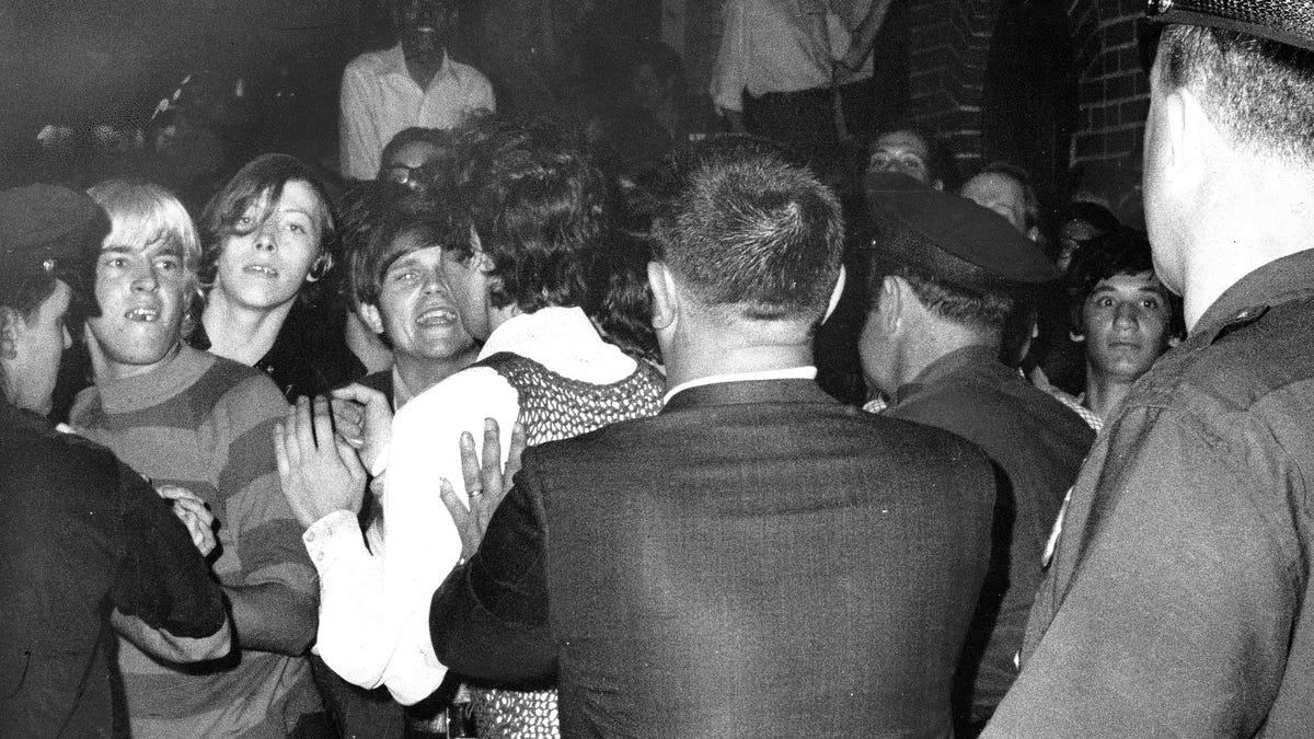 Crowd attempts to impede police arrests outside the Stonewall Inn on June 28, 1969Christopher Street in Greenwich Village.