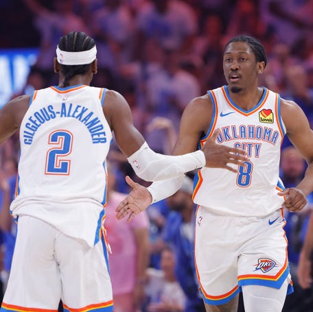 Jalen Williams (8) and Shai Gilgeous-Alexander celebrate after a scoring against the Denver Nuggets.