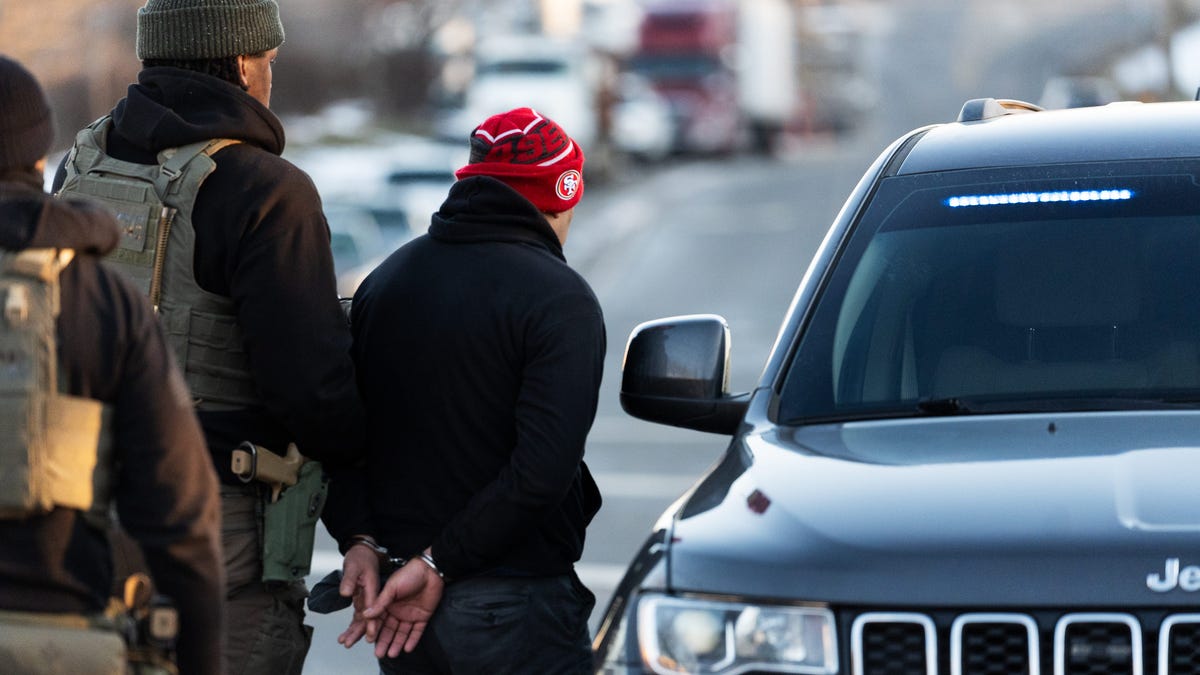 Immigration and Customs Enforcement (ICE) agents apprehend an immigrant from El Salvador after surveilling him for days, in Herndon, Virginia, on Jan. 15, 2025. The man had a criminal conviction and was in the country illegally.