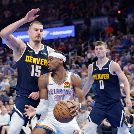 Mar 10, 2025; Oklahoma City, Oklahoma, USA; Denver Nuggets center Nikola Jokic (15) defends a drive by Oklahoma City Thunder guard Shai Gilgeous-Alexander (2) during the second half at Paycom Center. Mandatory Credit: Alonzo Adams-Imagn Images