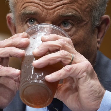Robert F. Kennedy, Jr., Secretary of the Department of Health and Human Services, drinks a beverage while he testifies in front of the Senate Health, Education, Labor, and Pensions Committee in Washington, D.C., on May 15, 2025.