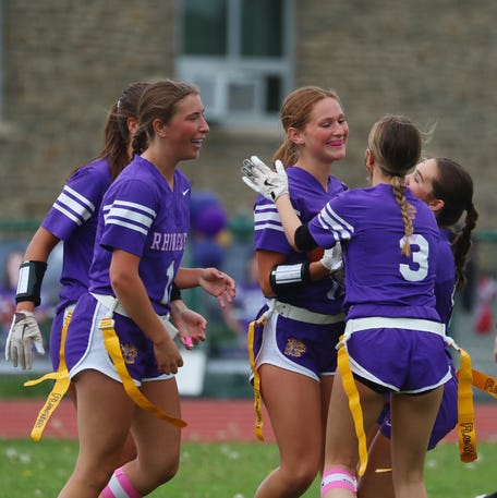 Rhinebeck teammates congratulate Macilyn Eighmy, center, in the end zone after her third touchdown catch against Saugerties during a flag football game on May 14, 2025.