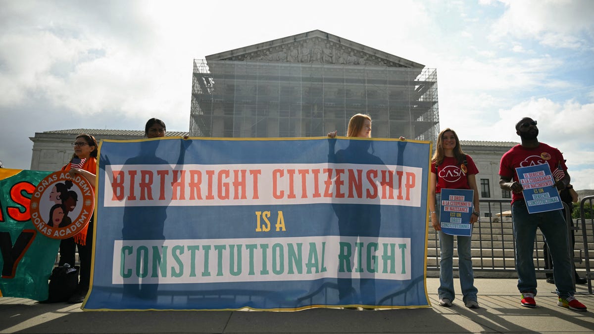 People outside the U.S. Supreme Court protest President Donald Trump's executive order on birthright citizenship as the court hears arguments over the order on May 15, 2025.
