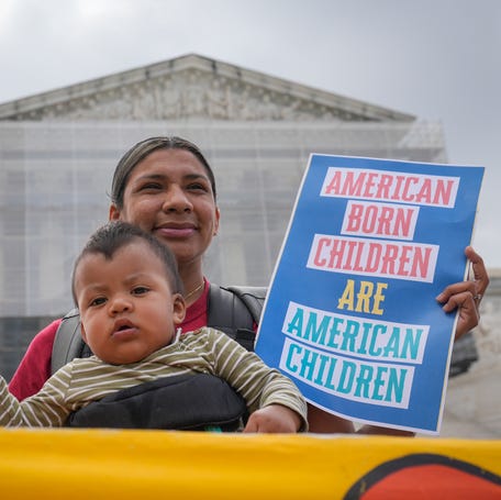 Olga Urbina and her child Ares Webster from Baltimore, MD, demonstrate outside the Supreme Court before justices hears oral arguments in Trump v. CASA, Inc. At issue in the case is if the Supreme Court should stay the district courts' nationwide preliminary injunctions on the Trump administration's executive order ending birthright citizenship.