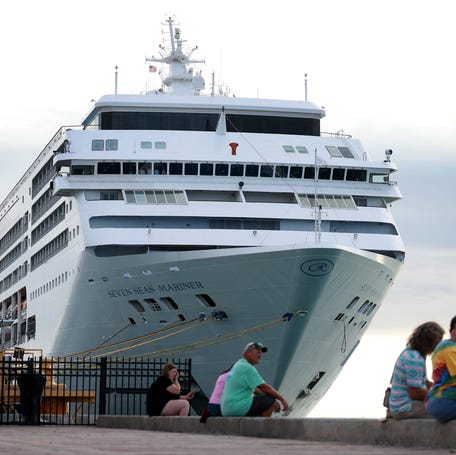 People enjoy Mallory Square as the Regent Seven Seas Mariner cruise ship is docked at the Mallory Square Dock on Dec. 01, 2023 in Key West, Florida.
