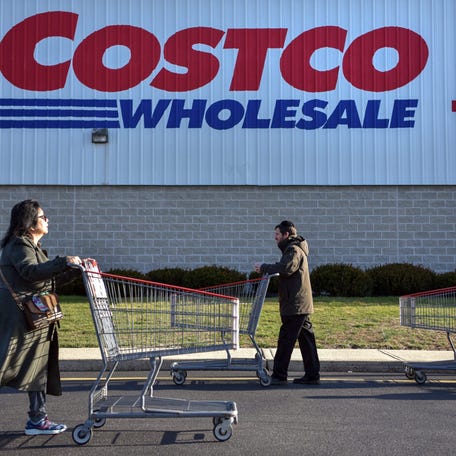 Shoppers wait in line before Costco Wholesale opens in Clifton on Wednesday, March 18, 2020.