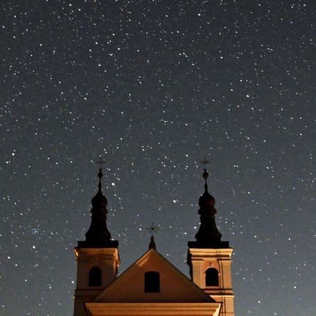 This long exposure picture shows a meteor crossing the night sky over the Post-Camaldolese monastery in the village of Wigry, Suwalki region, during the annual Perseids meteor shower early on August 12, 2024.