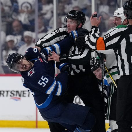 May 15: Winnipeg's Mark Scheifele falls after being punched by Dallas' Jamie Benn during the third period of Game 5. Winnipeg won 4-0.