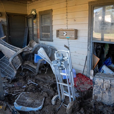 Mud cakes everything on the Gray family's back porch at River Ridge Apartments in Asheville, NC, on Sunday, October 20, 2024, after the remnants of Hurricane Helene caused historic flooding.