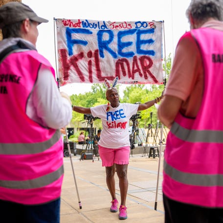 Nadine Seiler of Waldorf, Maryland, holds a sign that reads "What would Jesus Do? Free Kilmar" and a shirt that reads "Due Process Now" as she joins a group of protesters singing songs outside the U.S. District Court for the District of Maryland on May 16, 2025 in Greenbelt, Maryland. Protesters rallied outside the court during a hearing for a Maryland resident from El Salvador, Kilmar Abrego Garcia, who is detained in a notoriously violent maximum-security prison in El Salvador   after being deported last month.