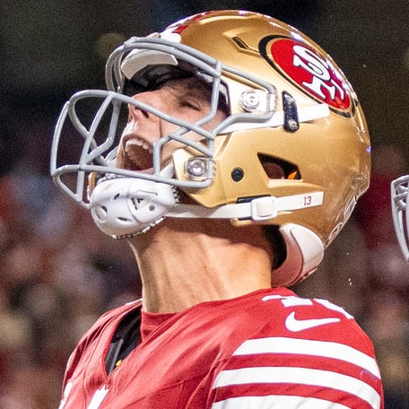 December 30, 2024; Santa Clara, California, USA; San Francisco 49ers quarterback Brock Purdy (13) celebrates with tight end George Kittle (85) after scoring a touchdown against the Detroit Lions during the second quarter at Levi's Stadium. Mandatory Credit: Kyle Terada-Imagn Images