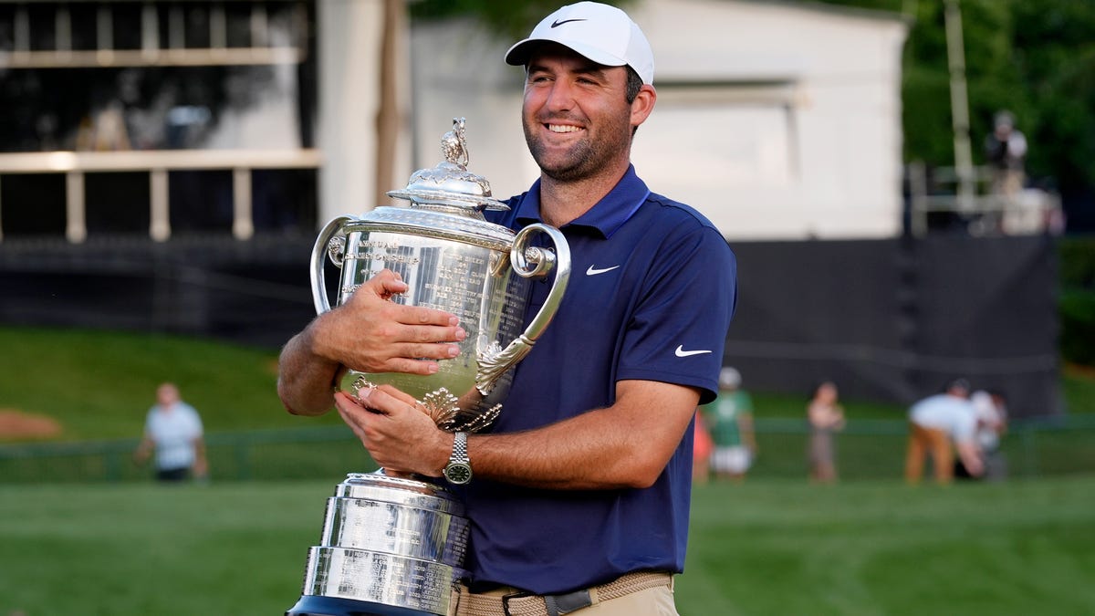 Scottie Scheffler holds the Wanamaker Trophy after winning the PGA Championship golf tournament at Quail Hollow.