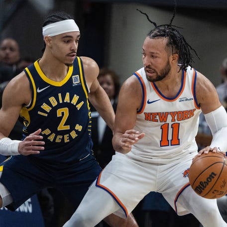 Feb 11, 2025; Indianapolis, Indiana, USA; New York Knicks guard Jalen Brunson (11) dribbles the ball while Indiana Pacers guard Andrew Nembhard (2) defends in the first half at Gainbridge Fieldhouse. Mandatory Credit: Trevor Ruszkowski-Imagn Images